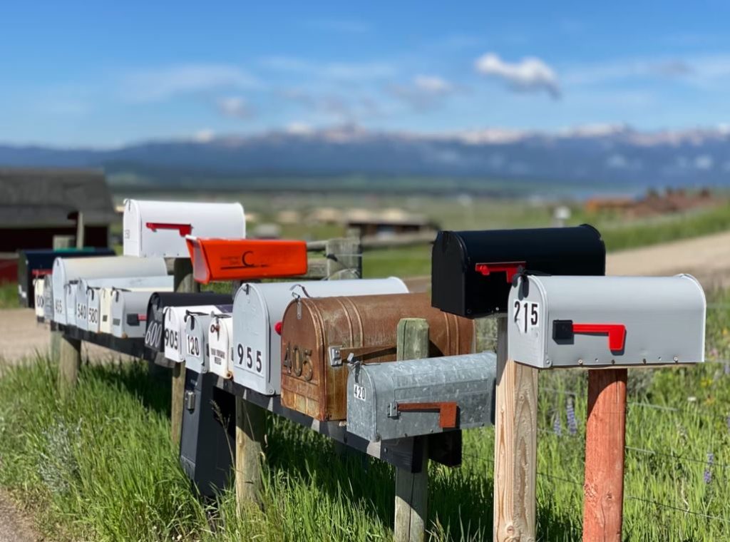 8 mailboxes along the side of a rural road